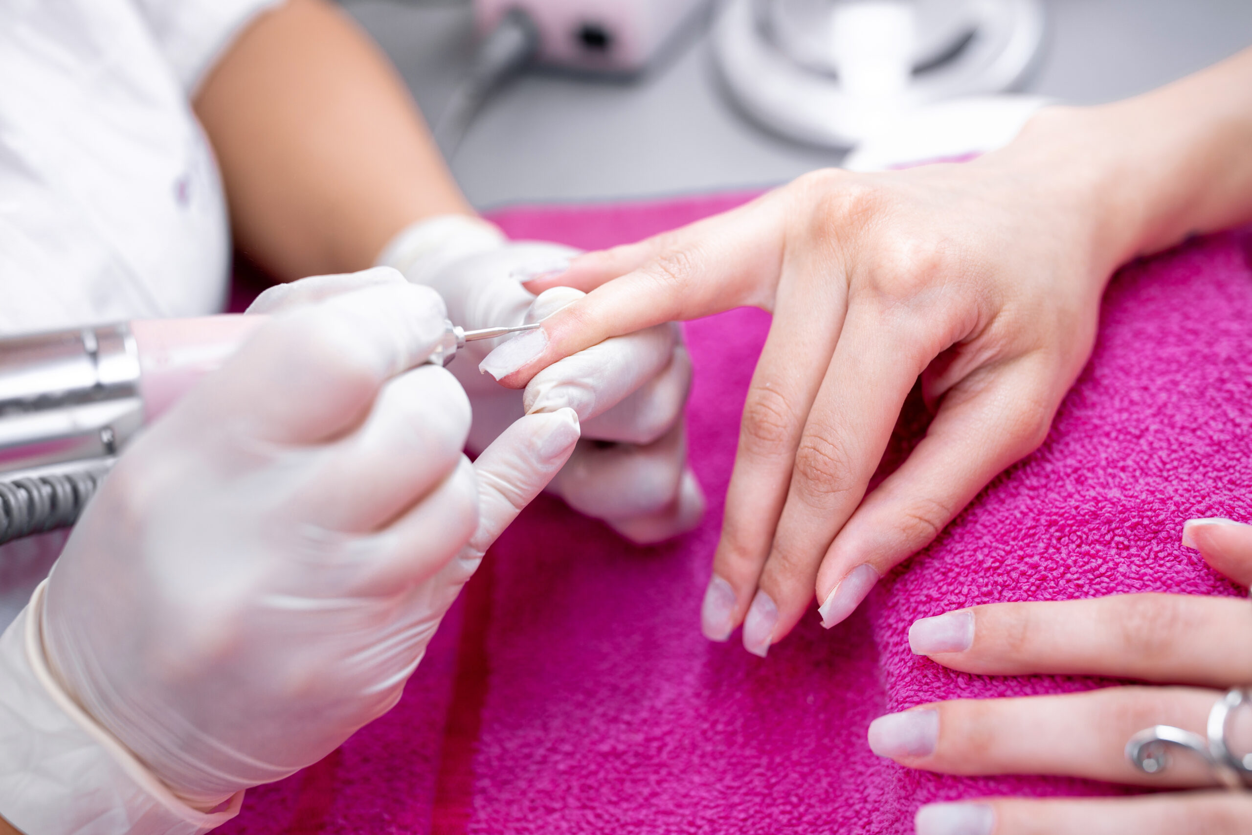 Manicurist taking care of her clients nails with style, healthy nails
